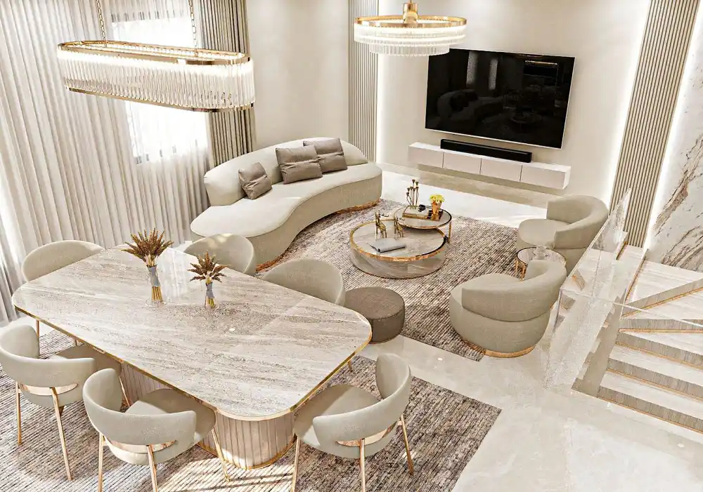 Modern dining table with marble top, gold legs, two upholstered chairs, pendant light, and round wall mirror.