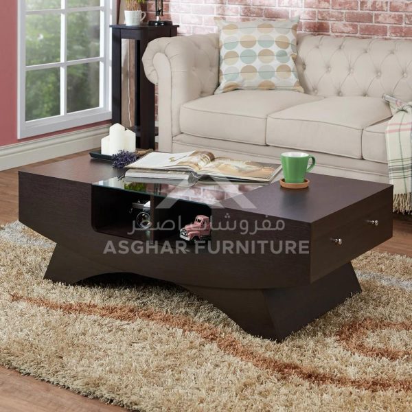 A dark brown wooden coffee table with a modern geometric design, a glass insert, and a drawer.