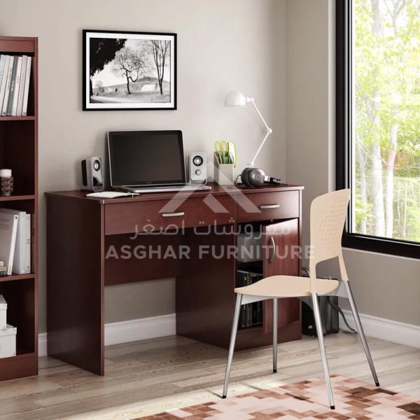 A compact wooden desk with a laptop, lamp, and two drawers, accompanied by a light-colored chair.