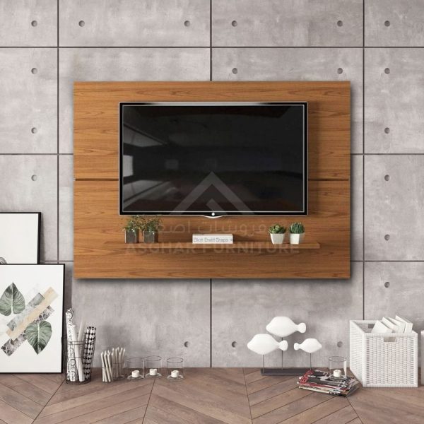 A modern wall-mounted TV unit with a wooden back panel, a single shelf, and a large television.