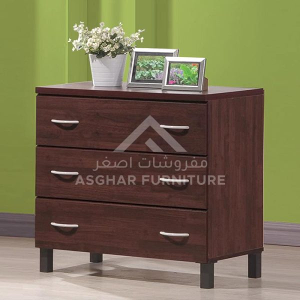 A simple dark wood chest of drawers with three drawers and silver handles.