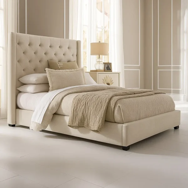 A luxurious beige upholstered king-size bed with a tufted headboard, two pillows, and a throw blanket.
