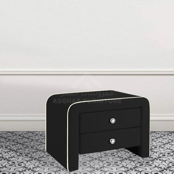 A contemporary black nightstand with two drawers, curved edges, and silver knobs, on a patterned rug.