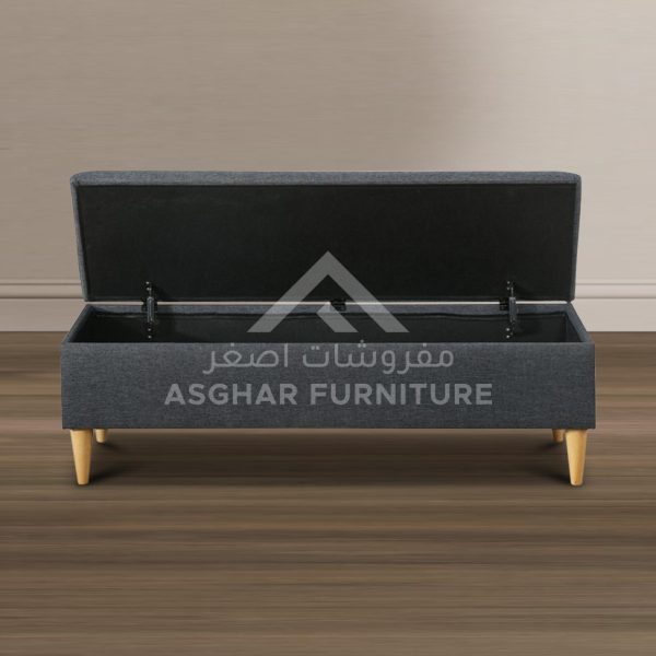 A rectangular dark grey upholstered storage bench with a hinged lid and light wood splayed legs.