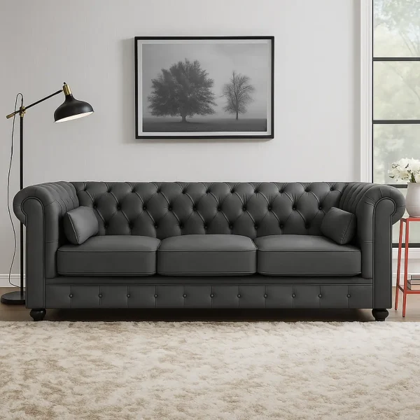 A modern take on a classic Chesterfield sofa in a dark gray leather or faux leather. It features a deep-button tufted back and rolled arms.