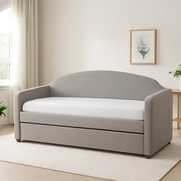 A modern grey daybed with a white mattress and pull-out trundle, perfect for small spaces, on a light rug.
