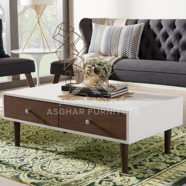 A contemporary two-tone coffee table with a white top and two dark brown drawers, supported by angled wooden legs.