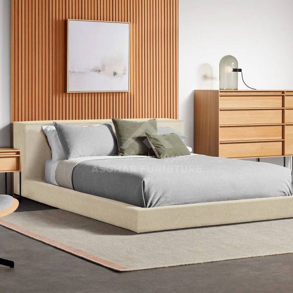 A contemporary bedroom with a light-colored platform bed and gray bedding, against a slatted wood accent wall.