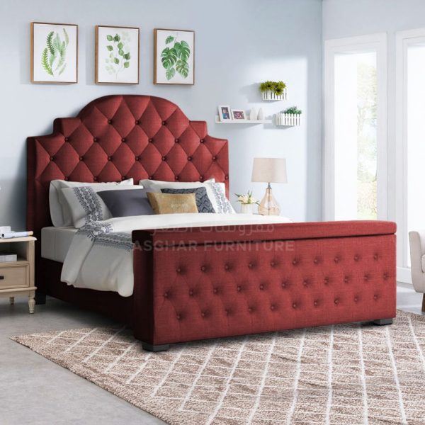 A luxurious red upholstered bed with a high tufted headboard and a tufted footboard that opens for storage.