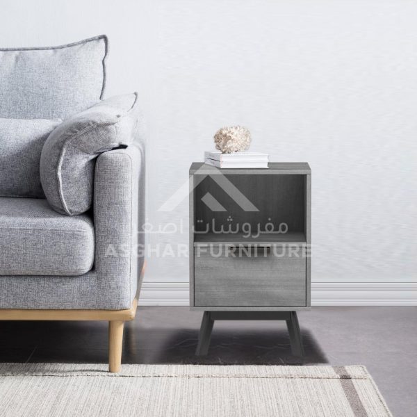 A compact grey wooden nightstand with an open shelf and a single drawer, on splayed legs.