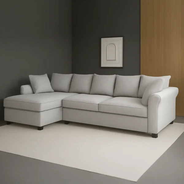 A gray L-shaped sectional sofa with a left-hand chaise lounge, set against a dark gray wall with a white frame.