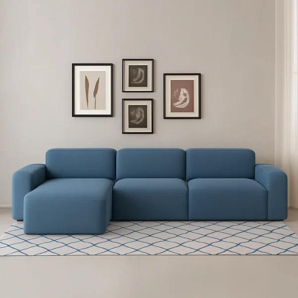 A light blue modular L-shaped sofa with a left-hand chaise lounge, sitting on a white and blue patterned rug.