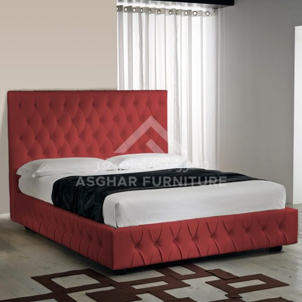 A contemporary red tufted upholstered bed with a high headboard and footboard.