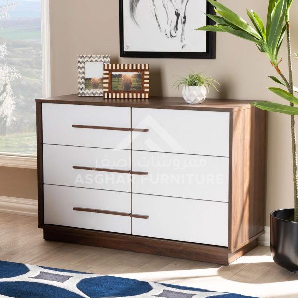 A two-toned brown and white dresser with six drawers, featuring minimalist brown handles and decor on top.