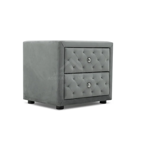 A chic grey velvet nightstand with two tufted drawers and silver knobs.