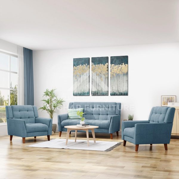 A light blue three-piece living room set, including a tufted sofa and two matching armchairs, all with wooden legs.