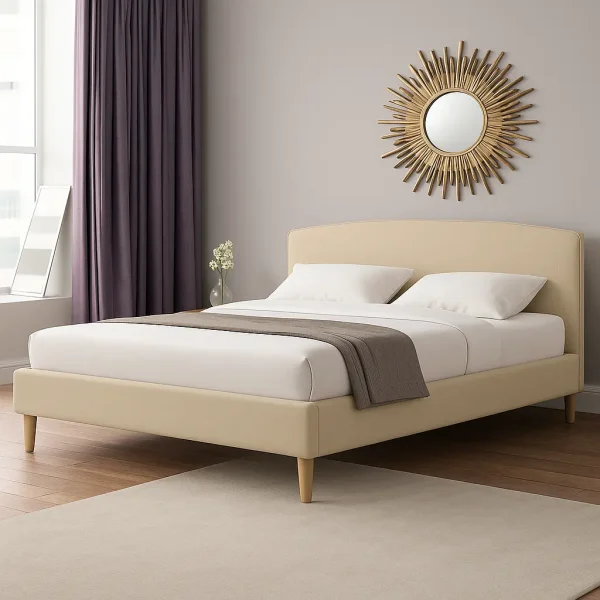 A modern bedroom features a cream-colored upholstered bed with rounded headboard, white bedding, and a sunburst mirror.