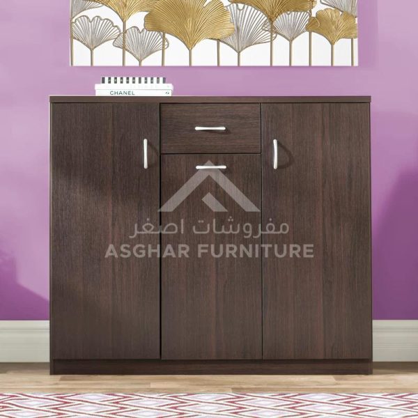 A compact dark brown shoe cabinet with two lower doors and one upper drawer, featuring silver handles.