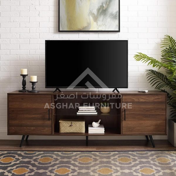 A modern dark wood TV unit with two cabinets and open shelves, with a television and a patterned rug.