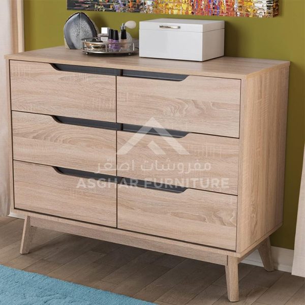 A modern light wood dresser with six drawers featuring cutout handles and splayed legs.