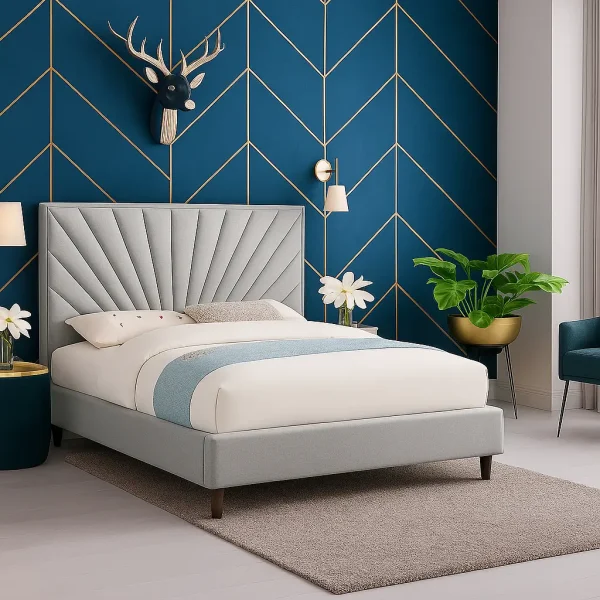 A gray upholstered bed with a fan-shaped headboard in front of a blue wall with a gold chevron pattern.