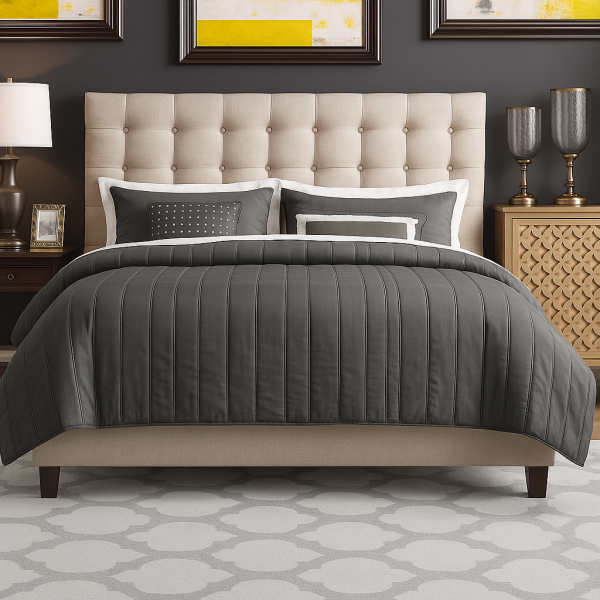 A beige tufted upholstered bed with a gray bedding and a patterned rug.