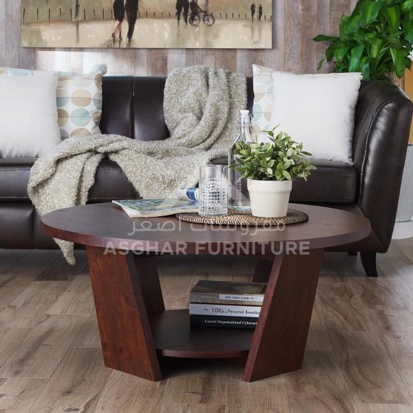 A dark brown round wooden coffee table with a modern design and a lower open shelf.