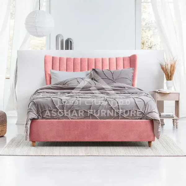 Modern pink upholstered bed with a tall, winged, vertically tufted headboard.