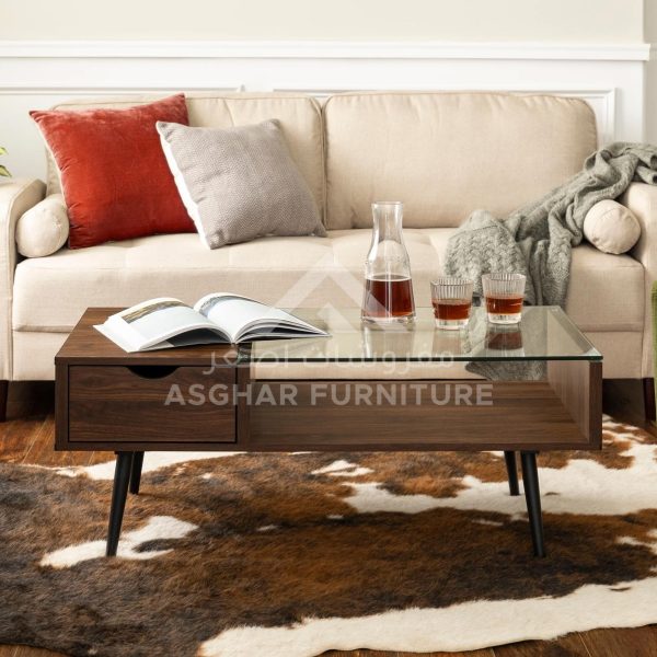 A mid-century modern coffee table with a dark wooden body, a glass tabletop, a drawer, and black metal legs.
