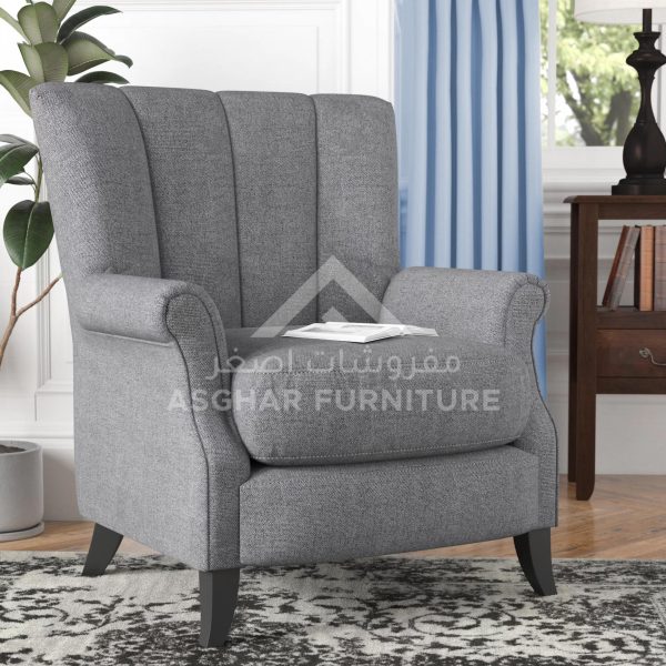 A modern grey armchair with a high back featuring vertical channel tufting and dark wooden splayed legs.