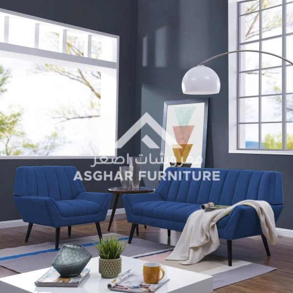 A blue fluted living room set with a two-seater sofa and a matching armchair, with a white coffee table.