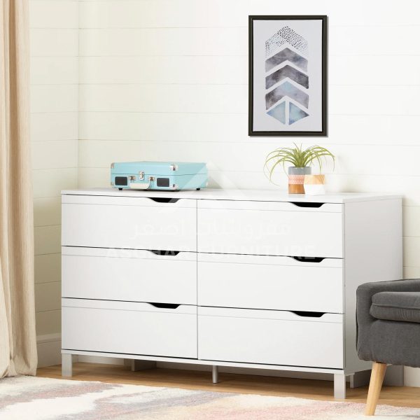 A sleek white six-drawer dresser with modern cutout handles, topped with a record player and plant.