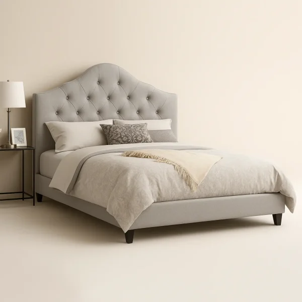 A modern gray tufted upholstered bed with a slightly arched headboard.