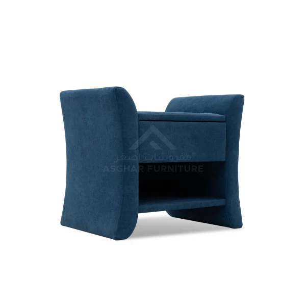 A unique blue upholstered nightstand with a single drawer, an open shelf, and curved side panels.