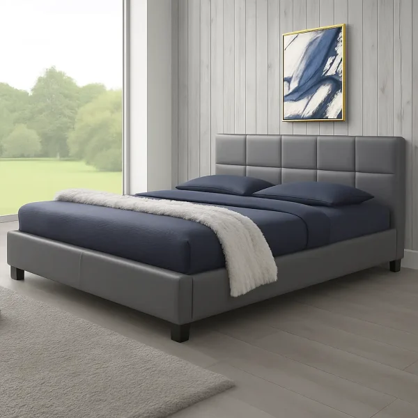 A clean white upholstered bed with blue and white bedding, and framed abstract art above it.