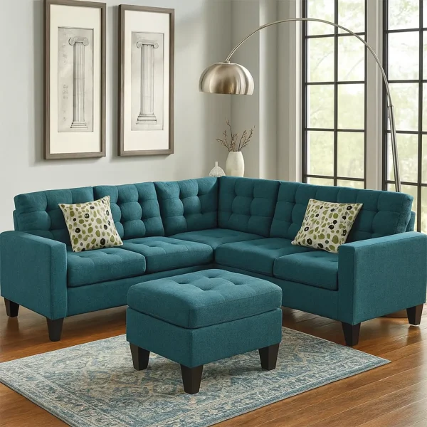 A teal blue tufted sectional sofa and a matching ottoman are placed on a patterned blue rug.