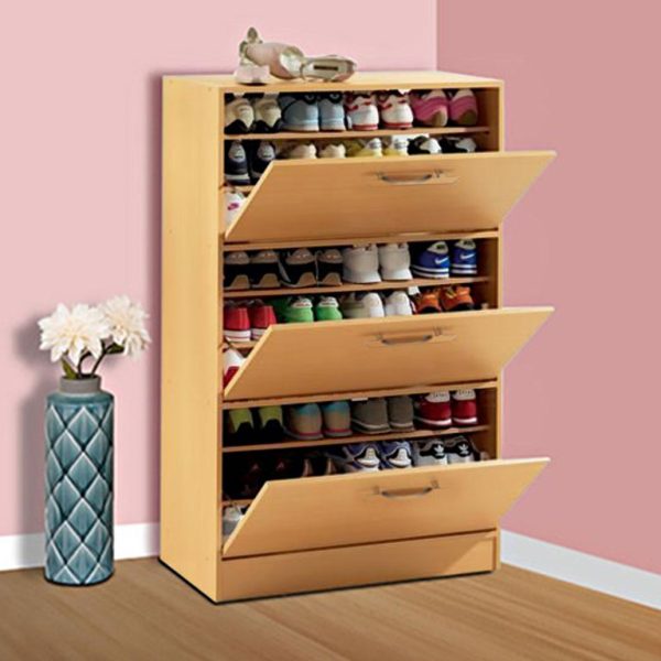 A light wooden shoe cabinet with four tilt-out shoe storage compartments.