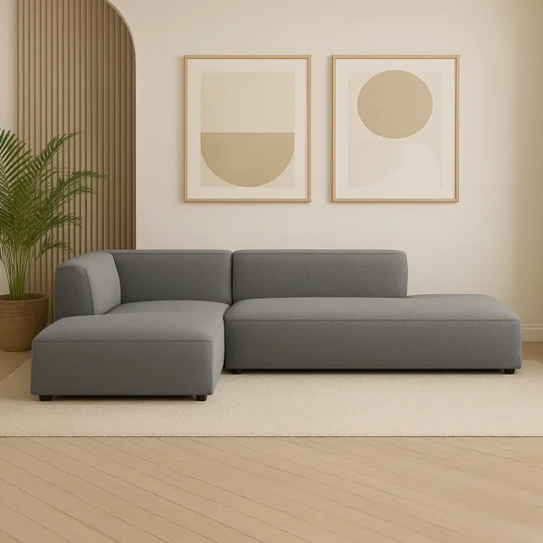 A contemporary gray modular sectional sofa with a chaise lounge. The sofa has a low profile, clean lines, and a minimalist design.