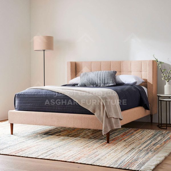 A contemporary beige upholstered bed with a square-tufted headboard.
