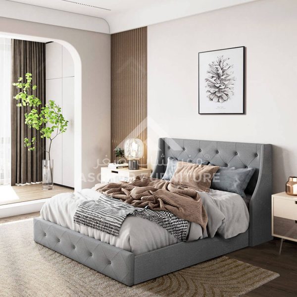 A light gray tufted bed with wingback headboard.