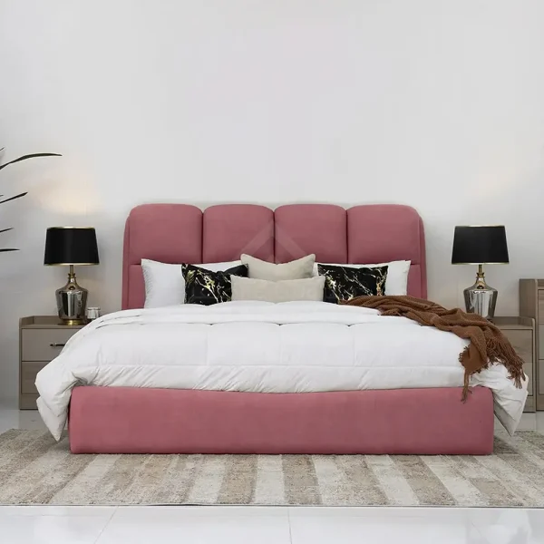 A stylish pink upholstered bed with a plain panel headboard.