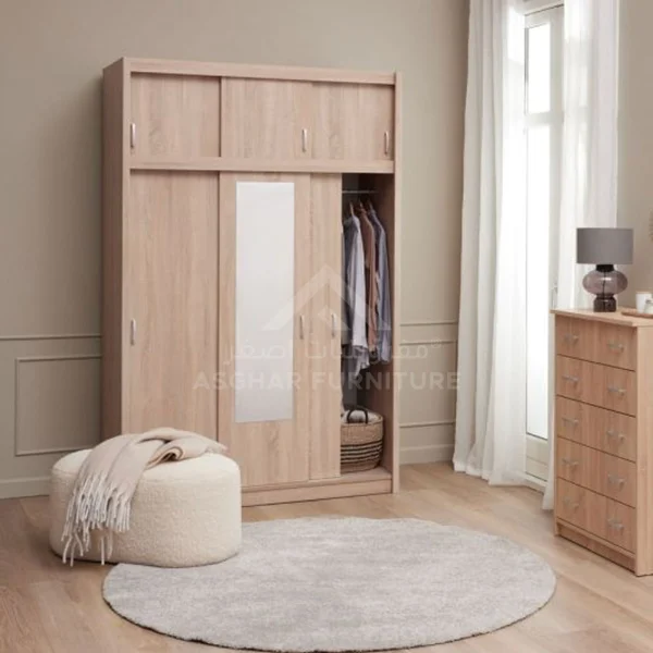A spacious light wood wardrobe with sliding doors, a central mirror, and an upper cabinet.
