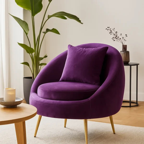 A vibrant purple, velvet armchair with a matching pillow and gold legs.