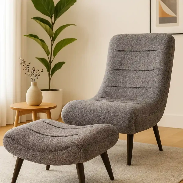 A mid-century modern gray upholstered accent chair with a matching ottoman.