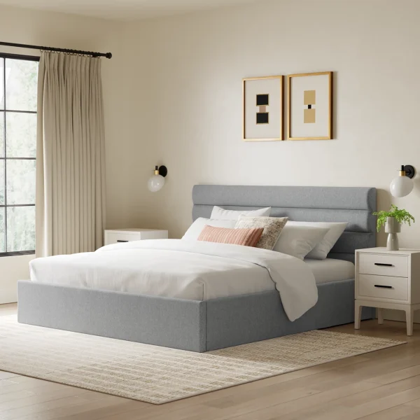A bedroom with a gray upholstered bed and headboard, two white nightstands and two pieces of art.