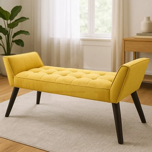 A tufted yellow upholstered bench with a curved back and dark wood legs.