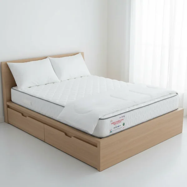 A white diamond-quilted mattress with gray piping on a light wood storage bed.