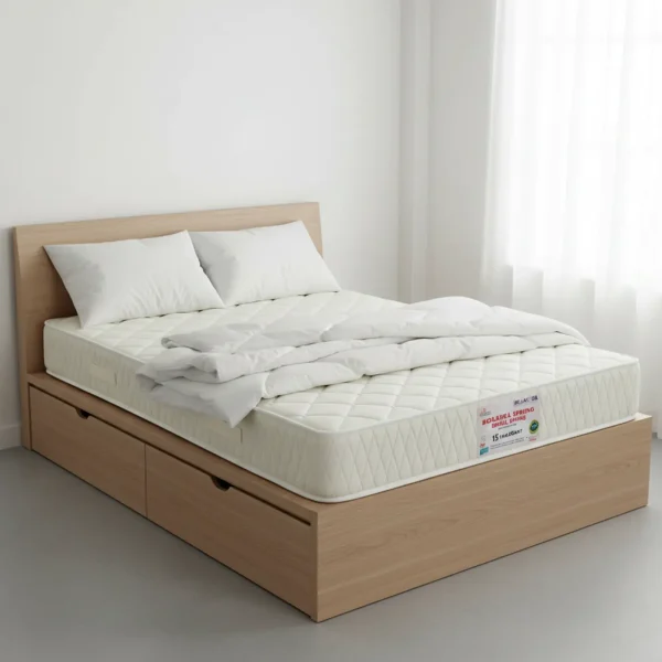 A quilted cream-colored mattress on a light wood storage bed with large drawers.