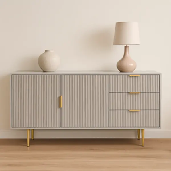 A light gray fluted sideboard with gold hardware and legs.