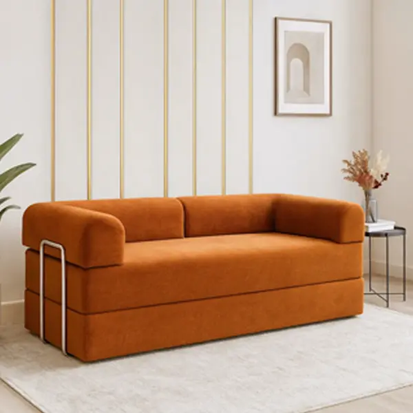 An orange loveseat with a bold, rounded design and chrome-finished legs in a modern living room.